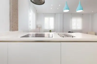 a white kitchen with a sink and a stove at ApartUP Valencia Opera in Valencia