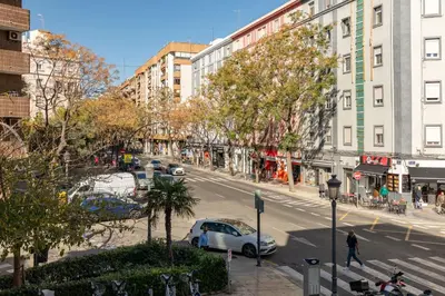 a city street with a car parked on the side of the road at ApartUP Valencia Opera in Valencia