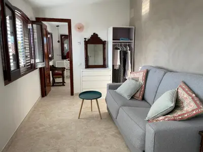 a living room with a gray couch and a stool at Chalet Las Brisas in Cullera
