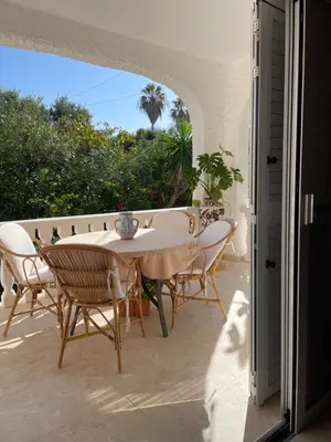 a patio with a table and chairs on a balcony at Chalet Las Brisas in Cullera