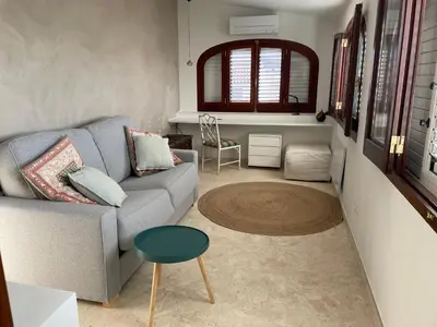 a living room with a couch and a table at Chalet Las Brisas in Cullera