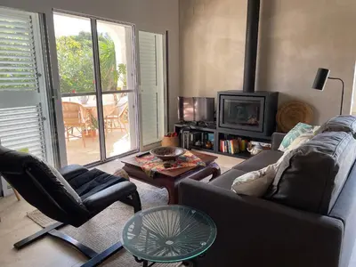 a living room with a couch and chairs and a tv at Chalet Las Brisas in Cullera