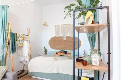 a bedroom with a bed and a room with a shelf at AL5 Seaside Bliss-stylish loft steps from Malvarrosa in Valencia