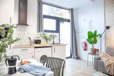 a kitchen with a washing machine in a room at AL5 Seaside Bliss-stylish loft steps from Malvarrosa in Valencia