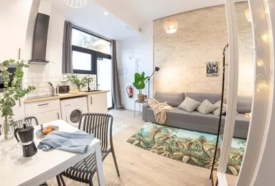 a living room with a couch and a table at AL5 Seaside Bliss-stylish loft steps from Malvarrosa in Valencia