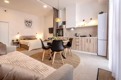 a kitchen and a living room with a table and chairs at Increíble Loft junto a la ciudad de las ciencias in Valencia
