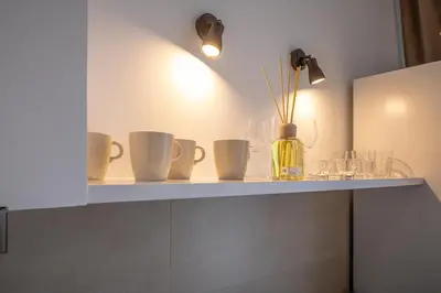 a shelf with cups and a vase on it at Increíble Loft junto a la ciudad de las ciencias in Valencia