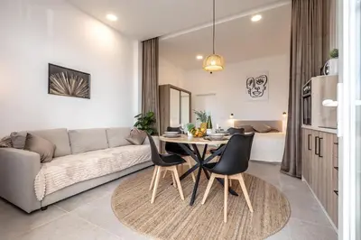 a living room with a couch and a table and chairs at Increíble Loft junto a la ciudad de las ciencias in Valencia