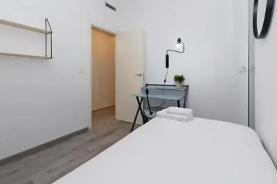 a bedroom with a bed and a table with a lamp at GuestReady - El Cabanyal Hidden Oasis in Valencia