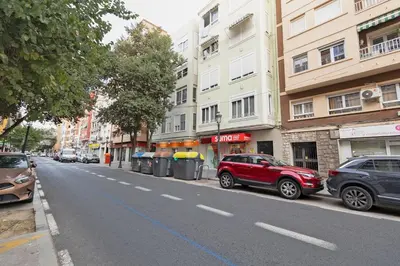 a red car parked on the side of a street at GuestReady - El Cabanyal Hidden Oasis in Valencia
