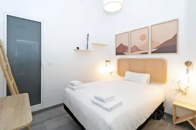 a small bedroom with a white bed and a desk at GuestReady - El Cabanyal Hidden Oasis in Valencia