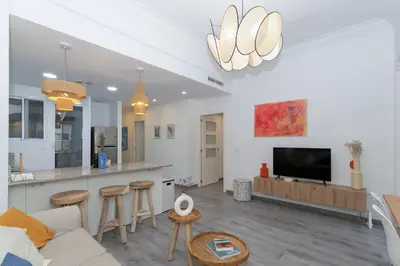a living room with a couch and a tv at GuestReady - El Cabanyal Hidden Oasis in Valencia