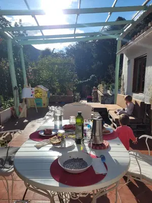 a table with plates of food on a patio at Trocito de Paraíso en la Sierra Espadán in Eslida