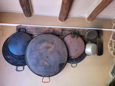 a group of pots and pans hanging on a wall at Trocito de Paraíso en la Sierra Espadán in Eslida