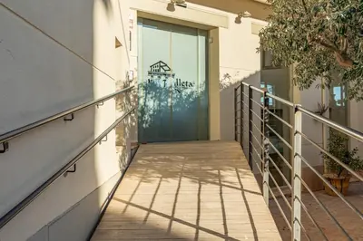 a door to a building with a walkway at Maison Muralleta B&B in Riba-Roja De Turia