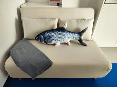 a fish toy sitting on top of a couch at CariSan1 - 6 min to beach, modern, bright in Valencia