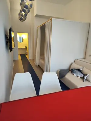 a living room with a couch and two white chairs at CariSan1 - 6 min to beach, modern, bright in Valencia