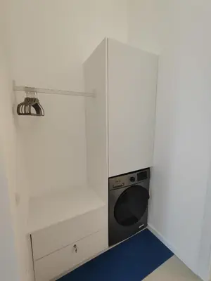a small room with a bed and a blue carpet at CariSan1 - 6 min to beach, modern, bright in Valencia