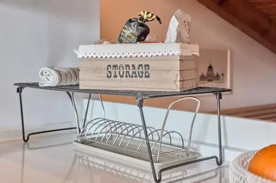 a cake on a metal stand with boxes on it at Sunny Cozy Penthouse with a Terrace at Plaza del Carmen in Valencia