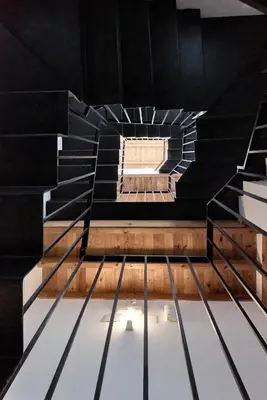 a spiral staircase in a building with a window at Sunny Cozy Penthouse with a Terrace at Plaza del Carmen in Valencia