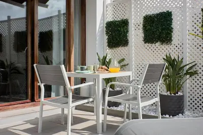 a white table and two chairs on a patio at Sunny Cozy Penthouse with a Terrace at Plaza del Carmen in Valencia
