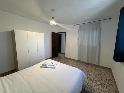 a bedroom with a white bed with towels on it at La Casa de Matilde in Caudiel