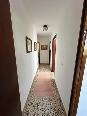 a hallway with white walls and a rug on the floor at La Casa de Matilde in Caudiel