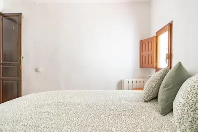 a bedroom with a large bed with green pillows at Casa la Baronia in Chulilla