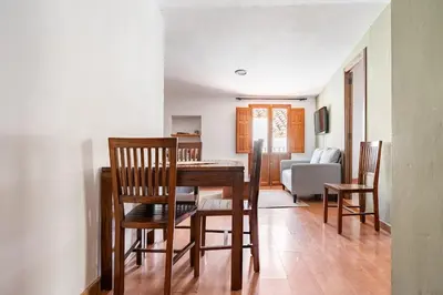 a dining room and living room with a table and chairs at Casa la Baronia in Chulilla