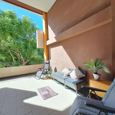 a patio with a couch and chairs and a large window at Casa Lliri con piscina en Massalfassar VALENCIA in Masalfasar