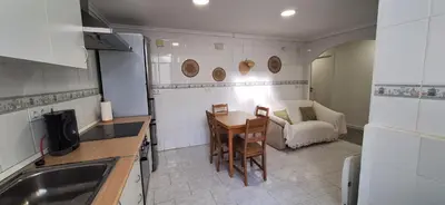 a small kitchen with a table and a couch at La Cantora in Sagunto