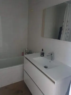 a white bathroom with a sink and a mirror at Apartamento primerísima línea in Port Saplaya