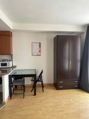 a kitchen with a table and a cabinet in a room at A studio-apartment in a newly built house.WIFI in Valencia