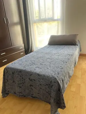 a bedroom with a bed with a laptop on it at A studio-apartment in a newly built house.WIFI in Valencia