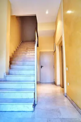 a staircase in a building with a white door at A studio-apartment in a newly built house.WIFI in Valencia