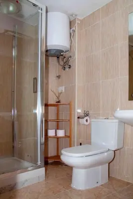 a bathroom with a toilet and a shower and a sink at A studio-apartment in a newly built house.WIFI in Valencia