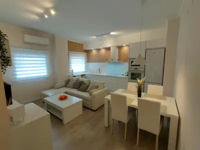 a living room with a couch and a table with chairs at Non Stress Turia in Valencia