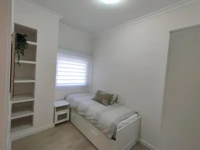 a white bedroom with a bed and a window at Non Stress Turia in Valencia