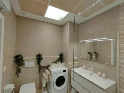 a bathroom with a washing machine and a sink at Non Stress Turia in Valencia
