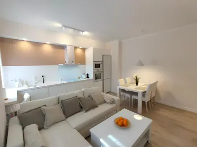 a living room with a white couch and a table at Non Stress Turia in Valencia