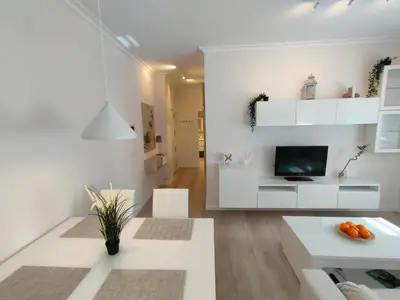 a living room with white furniture and a tv at Non Stress Turia in Valencia