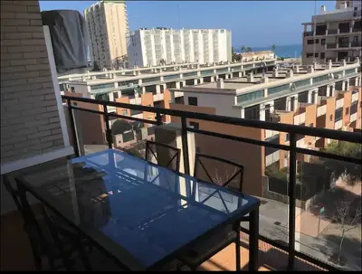 a blue table on the balcony of a building at Piso acogedor con vistas al mar in La Torre