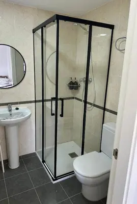 a bathroom with a shower with a toilet and a sink at Piso acogedor con vistas al mar in La Torre