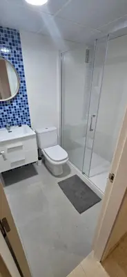 a bathroom with a shower and a toilet and a sink at Piso acogedor con vistas al mar in La Torre