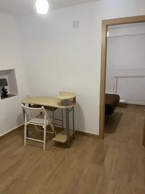a small table and a chair in a room at Apto. Rural Cielo. Al lado Torre in Jérica