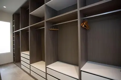 a walk in closet with brown walls and white shelves at SingularStays Picaña in Picanya