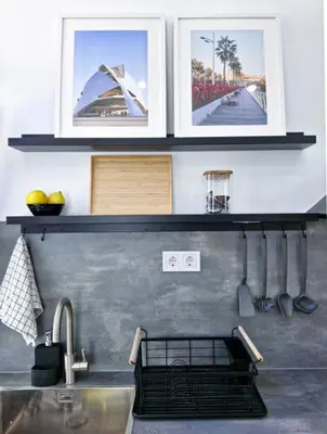 a kitchen with three pictures on the wall above a sink at Apartamento nuevo cerca de la playa y céntrico in Valencia