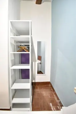 a room with white shelves and a mirror at Bello apartamento cerca de la Plaza Redonda in Valencia