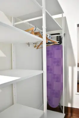a closet with white shelves and a purple bag at Bello apartamento cerca de la Plaza Redonda in Valencia