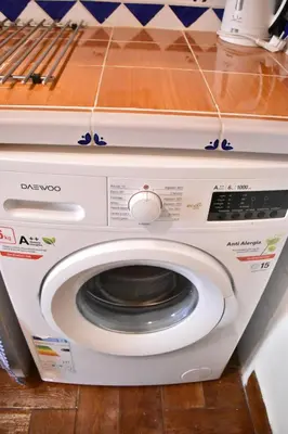 a white washing machine in a kitchen with a counter at Bello apartamento cerca de la Plaza Redonda in Valencia